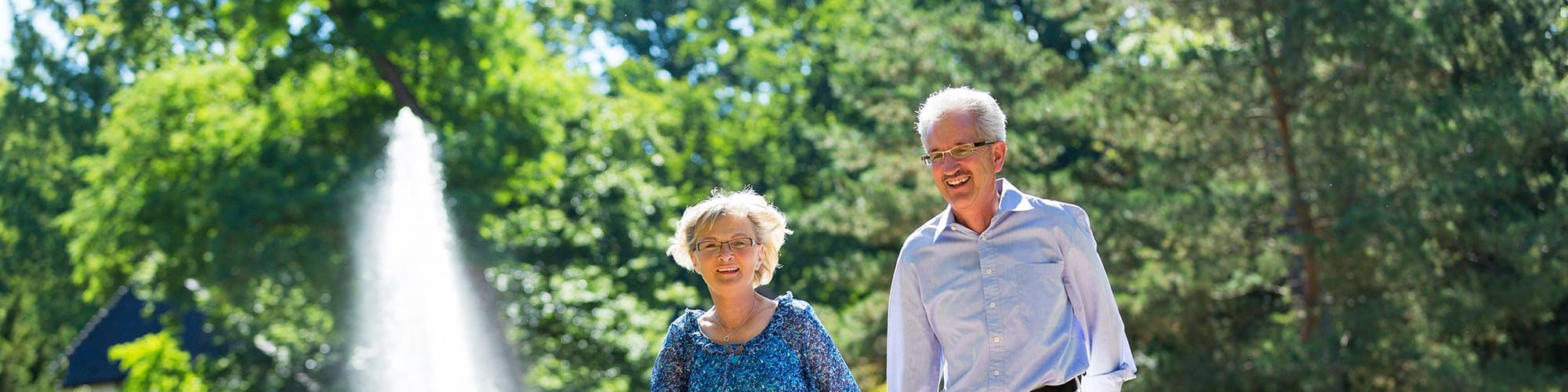Retired couple enjoy walking in a park